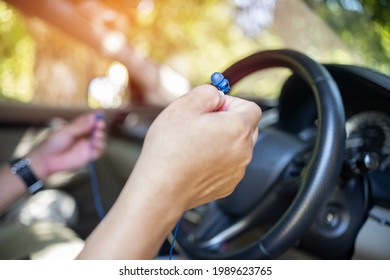 Close Up Ear Phone In Hand A Man Connect To Smartphone Use For  Hand Free With Drive A Car : Safety Transport Concept First Car Park And Connect Before Drive A Car