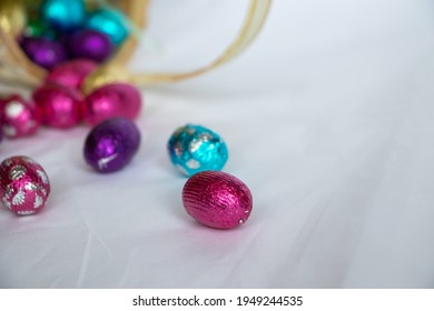 A Close Up Of Easter Eggs Falling Out Of An Easter Basket.