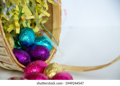 A Close Up Of Easter Eggs Falling Out Of An Easter Basket.