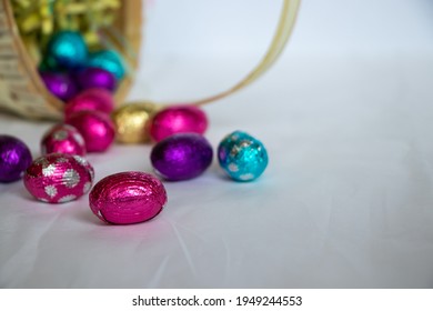 A Close Up Of Easter Eggs Falling Out Of An Easter Basket.