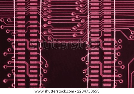 Close up of ed micro circuit board. Abstract technology background. Computer mechanism in details. Image toned in Viva Magenta, color of the 2023 year