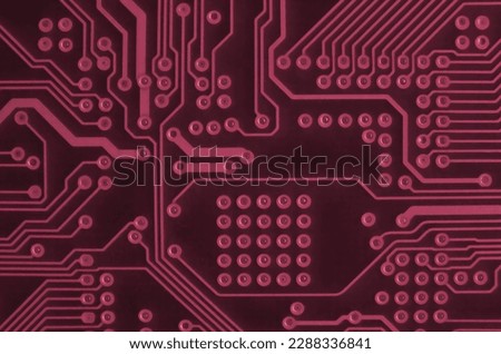 Close up of ed micro circuit board. Abstract technology background. Computer mechanism in details. Image toned in Viva Magenta, color of the 2023 year