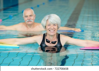 close up of elder couple doing exercises in the pool - Powered by Shutterstock