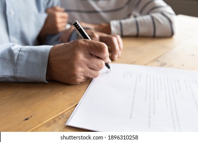 Close Up Elderly Senior Family Couple Signing Contract With Real Estate Agent Purchasing Accommodation, Making Agreement With Financial Advisor Or Putting Signature On Paper Medical Insurance.