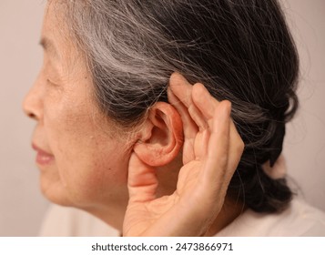 Close up of an elderly woman's ear.
