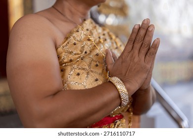 Close up of elderly womans hands, doing the traditional thai hand greetings. High quality photo