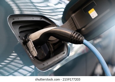 Close up of electric car inlet with a connected charging cable  - Shutterstock ID 2159177203