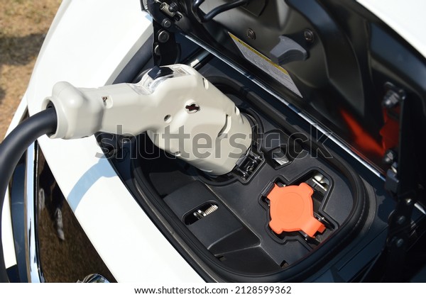 close up of Electric car vehicle\
mobile with plug in charger socket to recharge power\
bettery