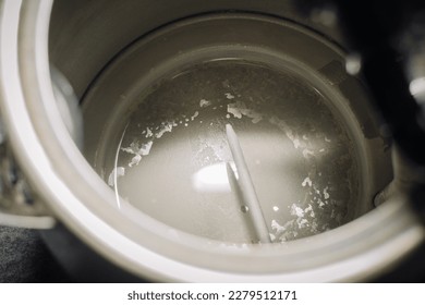Close up of electric kettle with limescale in hard water area, region. Top view. Selective focus. Preparation for descaling