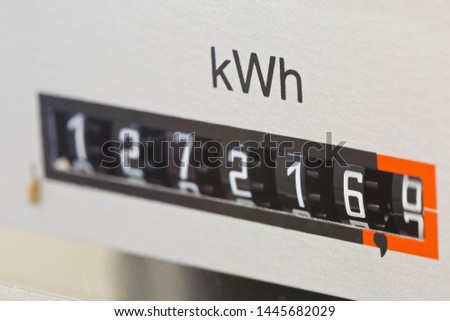 Close up of electric meter reader showing used kWh in private residential home with selective focus