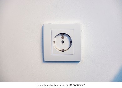 Close Up Of A Electrical Outlet On The Wall With Childproof.