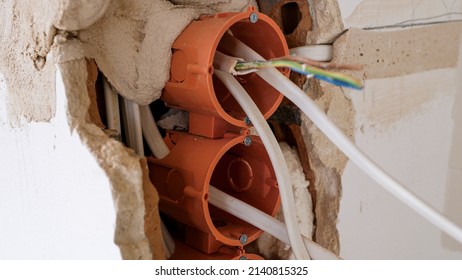 Close Up Of Electrical Wires Hanging From A Wall During Apartment Remodeling