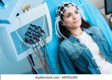 Close Up Of Electroencephalograph Recording Brain Waves Of Woman