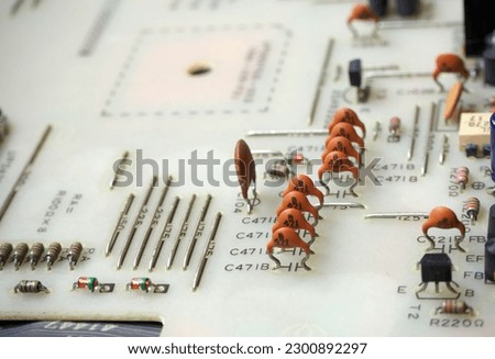 Close up of electronic components on a printed circuit board. Focused on ceramic disc capacitors.