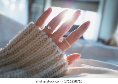 Close Up Of Elegant Diamond Ring On Female Finger In Morning Light. (soft And Selective Focus)