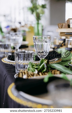 Close up of elegant event table setting with glassware and appetizer