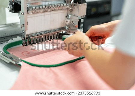 Close up of embroidery machine making patterns on textiles
