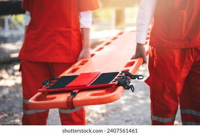 Close up of Emergency Rescue Team Holding Transfer Stretcher to Help Patient in Emergency Situation. Critical Medical Assistance and Rescue Services in Action