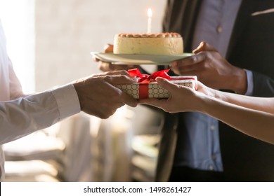Close Up Employees Congratulating Colleague With Birthday Or Promotion, Giving Gift Box With Bow And Cake With Candle, Party In Office, Friendly Workers Making Surprise, Corporate Celebration Concept