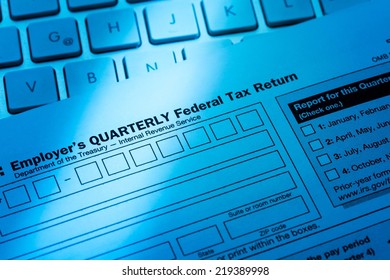 Close Up Of An Employer's Quarterly Federal Tax Return Form On A Computer Keyboard.