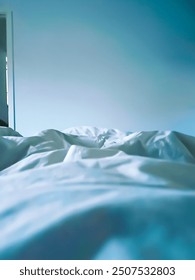 Close up empty bed and unmade at the first light of dawn
