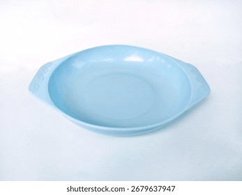 Close up of an empty blue ceramic plate with handles isolated on white background.