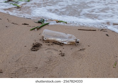 close up of empty bottle in beach