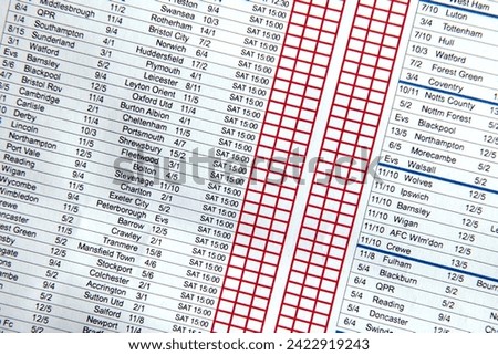 A close up of an empty football betting slip, with shallow depth of field. Red boxes available to make the selection and wager.
