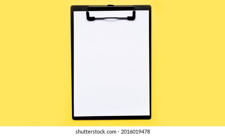 close up of empty paper on yellow background