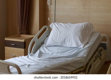 Close Up Empty Patient Hospital Bed With Nobody. Recovery Room With Bed And Comfortable Medical Equipped In A Hospital. Mattress With White Cloth