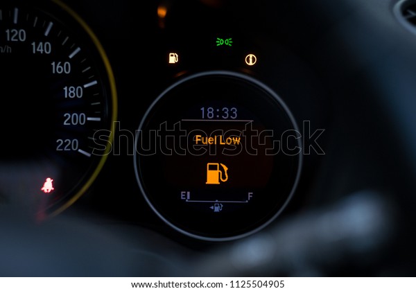 Close up\
empty Petrol, gasoline gauge dash board in car with digital warning\
sign of run out of fuel turn on on black background. Low level of\
fuel show on speedometer\
dashboard.