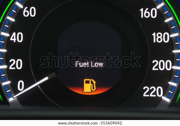 Close up\
empty Petrol, gasoline gauge dash board in car with digital warning\
sign of run out of fuel turn on on black background. Low level of\
fuel show on speedometer\
dashboard.