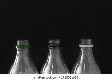 A Close Up Of Empty Plastic Soft Drink Bottles On A Black Background