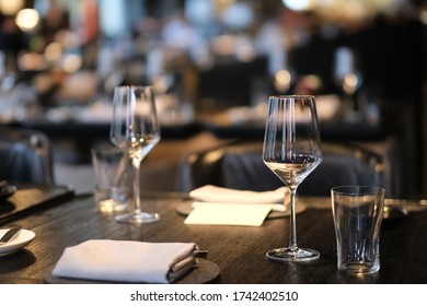 Close Up Empty Shiny Drinking Glass On Dining Table In Restaurant At Night