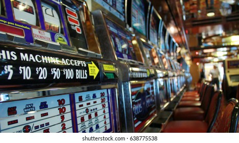 Close Up To An Empty Slot Machines Row And Chairs