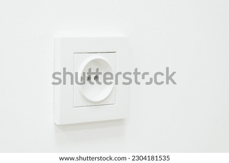 Close up of an empty socket on a white wall. Electricity concept, white outlet