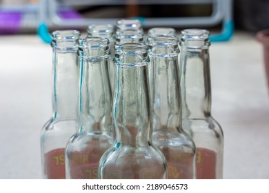 Close Up Empty Soft Drinks Glass Bottles On The Floor. Recycled Glass Concept.