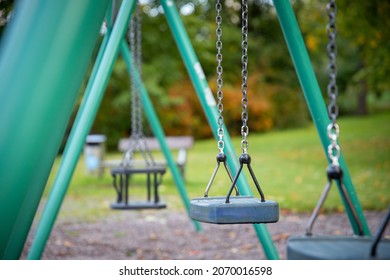 Close Up Of Empty Swing Set At Park.