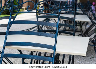 Close Up Of An Empty Table With Empty Chairs At A Local Outdoor Resturant.