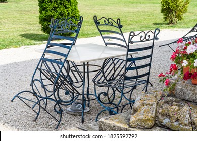 Close Up Of An Empty Table With Empty Chairs At A Local Outdoor Resturant.