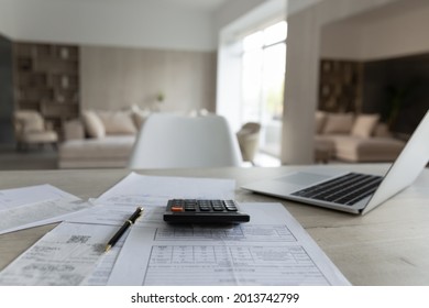 Close up of empty table at home with paper documents and bills for paying online on computer. No people, paper correspondence for managing budget or expenses, make payment on laptop. Finance concept. - Shutterstock ID 2013742799