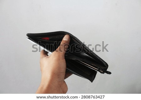 Close Up Empty Wallet Held in Hand Isolated on White Background Showing Financial Concept and Poverty