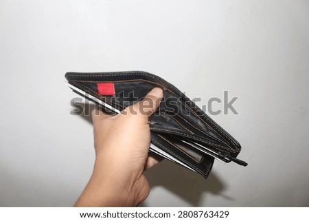 Close Up Empty Wallet Held in Hand Isolated on White Background Showing Financial Concept and Poverty