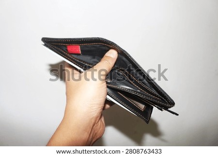 Close Up Empty Wallet Held in Hand Isolated on White Background Showing Financial Concept and Poverty