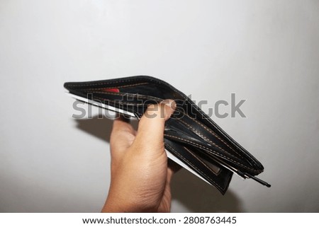 Close Up Empty Wallet Held in Hand Isolated on White Background Showing Financial Concept and Poverty