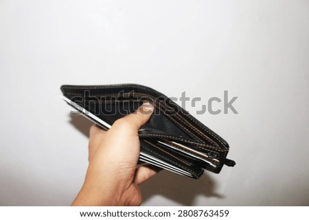 Close Up Empty Wallet Held in Hand Isolated on White Background Showing Financial Concept and Poverty