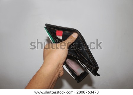 Close Up Empty Wallet Held in Hand Isolated on White Background Showing Financial Concept and Poverty