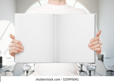 Close up of empty white book in man's hands. Mock up