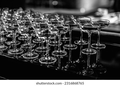 Close up Empty wine glasses on dark background, close up. a lot of empty glass wine glasses. monotone image. select focus and Blurred image with shinny and transparent of glass at night party.