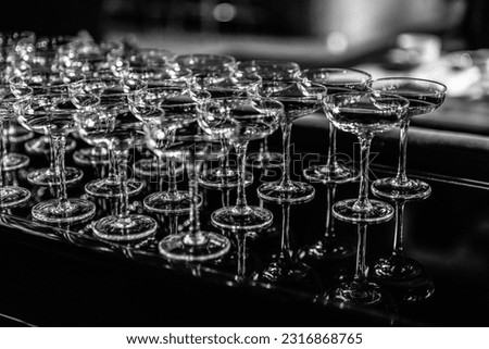 Close up Empty wine glasses on dark background, close up. a lot of empty glass wine glasses. monotone image. select focus and Blurred image with shinny and transparent of glass at night party.